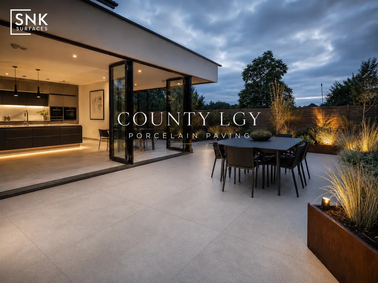 County LGY light grey porcelain paving on a modern UK garden patio with bi-fold doors