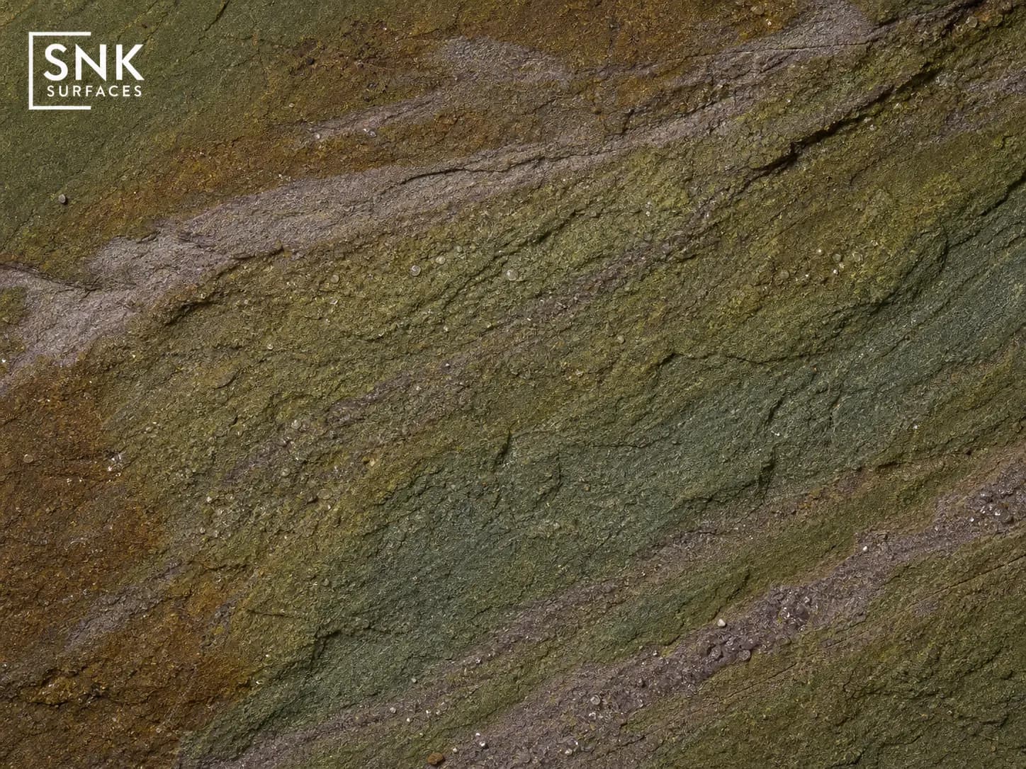 Macro close-up of raj green Indian sandstone showing natural olive green, warm brown, and grey colour variations with quartz detail
