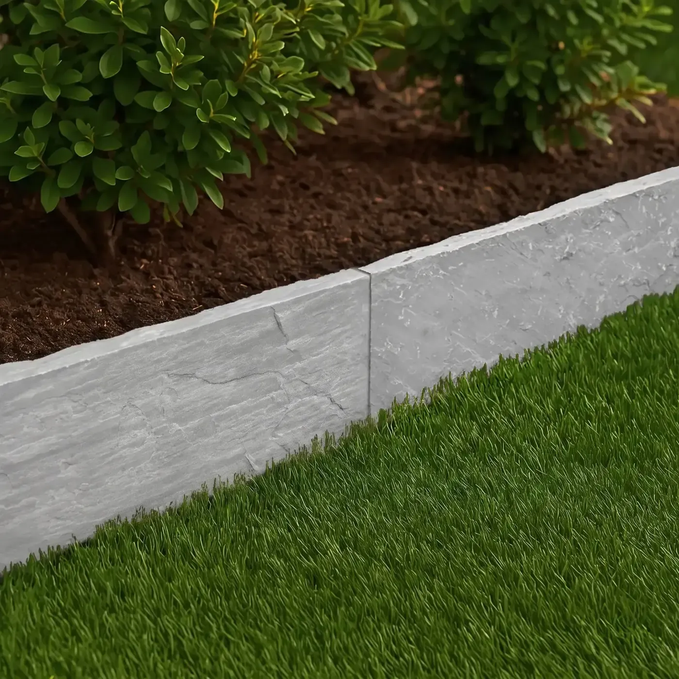 Kandla Grey sandstone edging beside green planting and lawn
