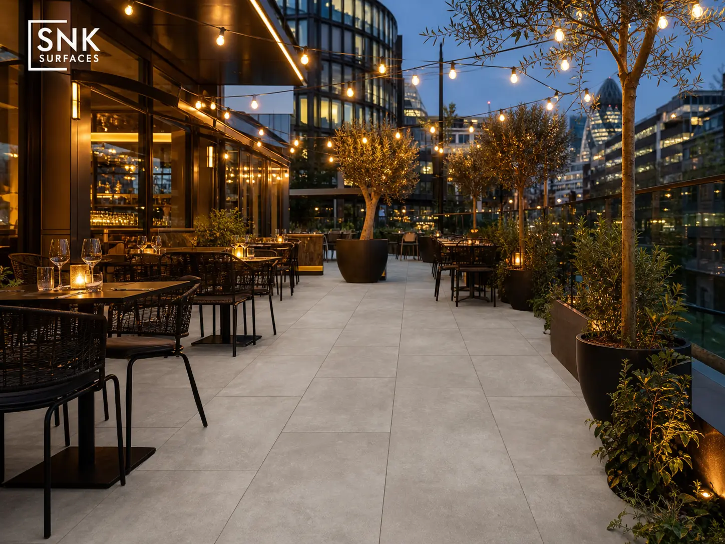 Modern UK commercial outdoor dining terrace paved with County LGY light grey porcelain slabs
