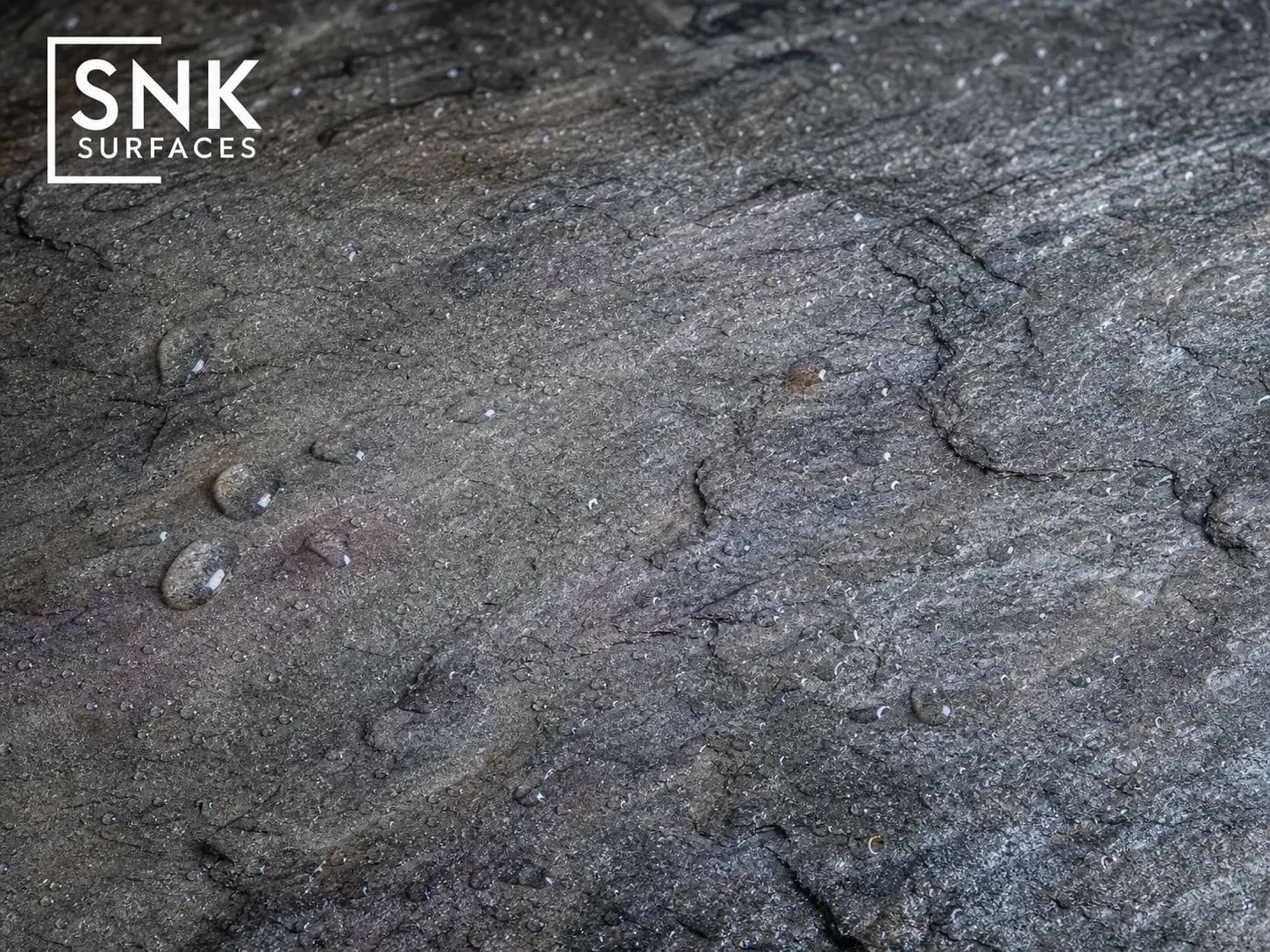 Macro close-up of wet Kandla Grey Indian sandstone showing subtle blue and purple mineral undertones