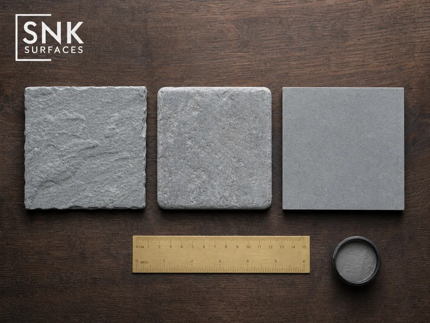 Three Kandla Grey sandstone samples showing riven, tumbled, and sawn-and-honed finishes side by side